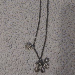 Long silver like necklace with 5 attached charms